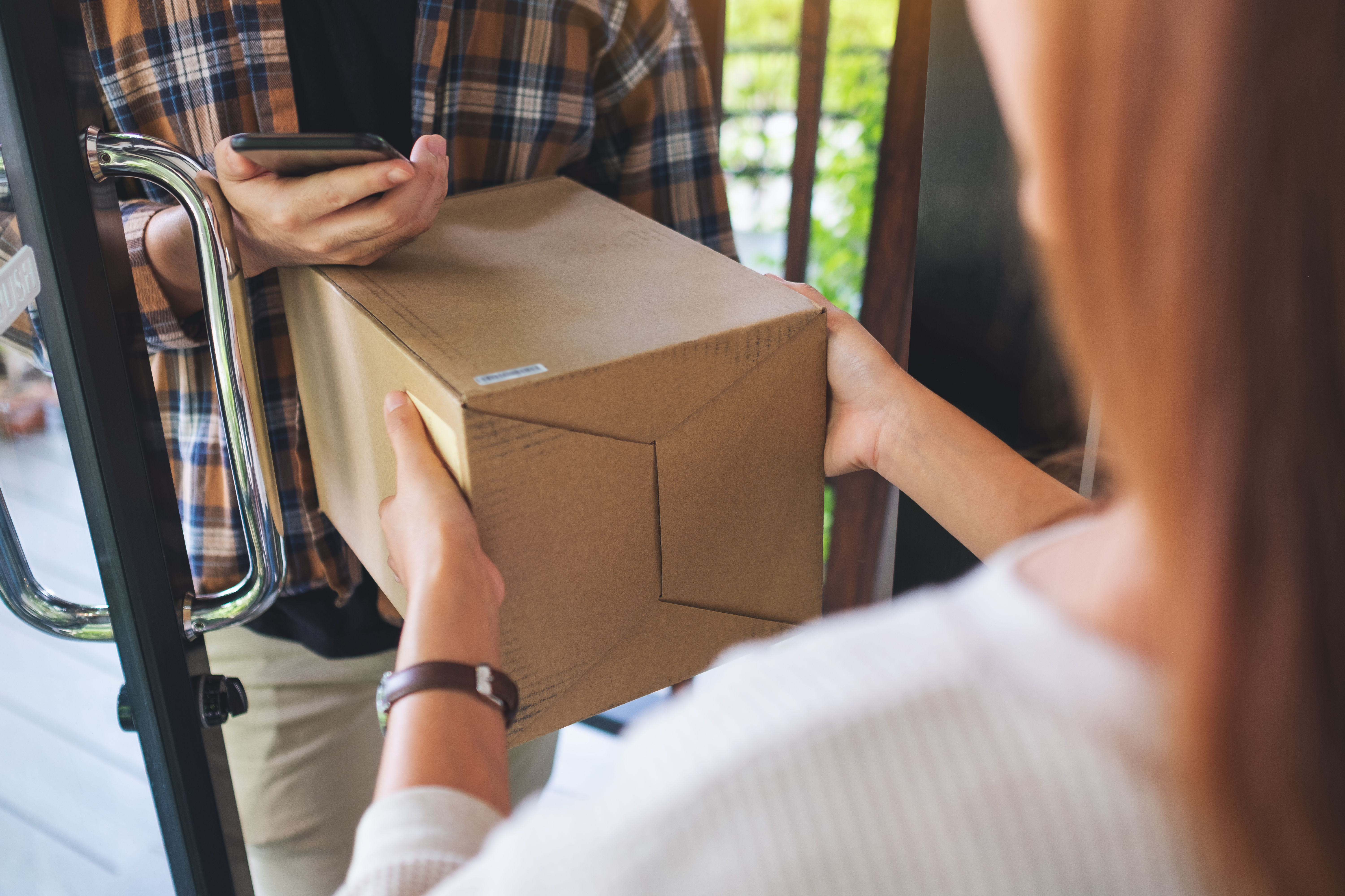 closeup-image-of-a-woman-receiving-parcel-box-from-2023-11-27-05-10-28-utc